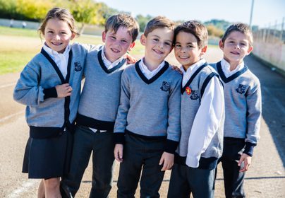 Primary kids smiling outside