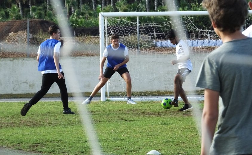 Boys playing football outside