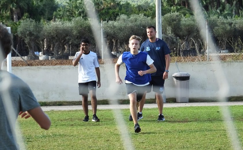Sixth Form Student playing football outside
