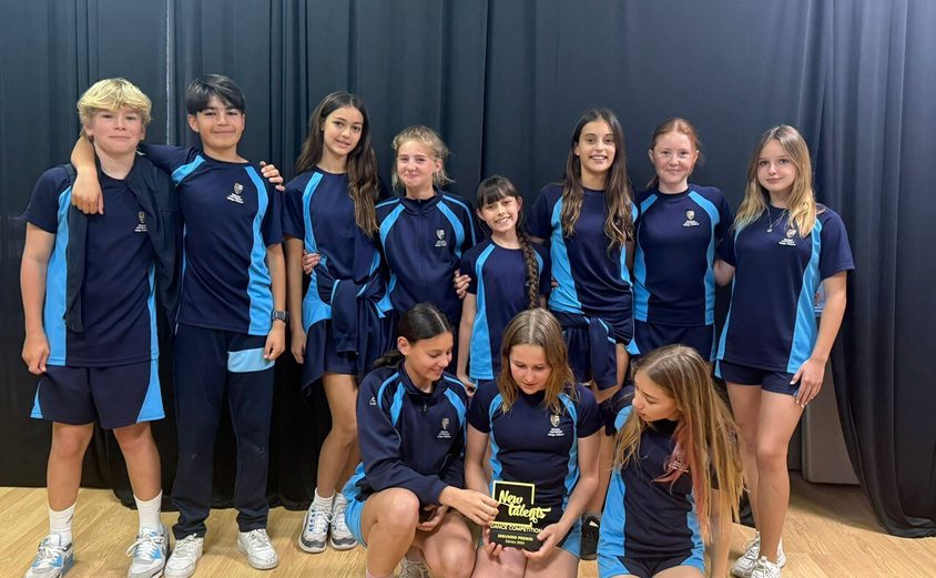 Group of dancers posing with award in their sports clothes