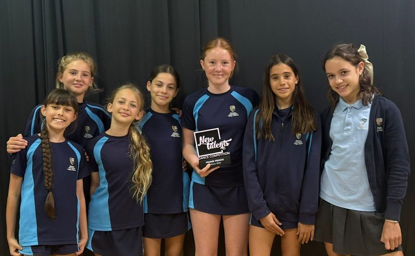 Group of girls holidng award for dance competition in sports clothes