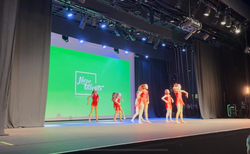 Group of girls in red leotards performing on stage