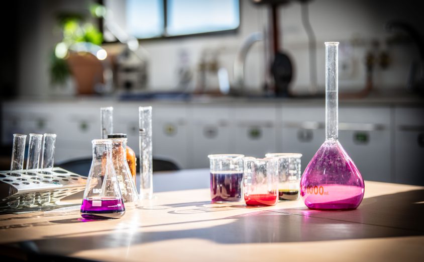 Colourful chemical liquids on table in science lab