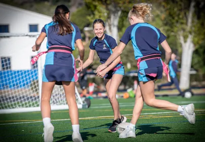 Secondary girls running for ruby ball on school Astro Turf 1