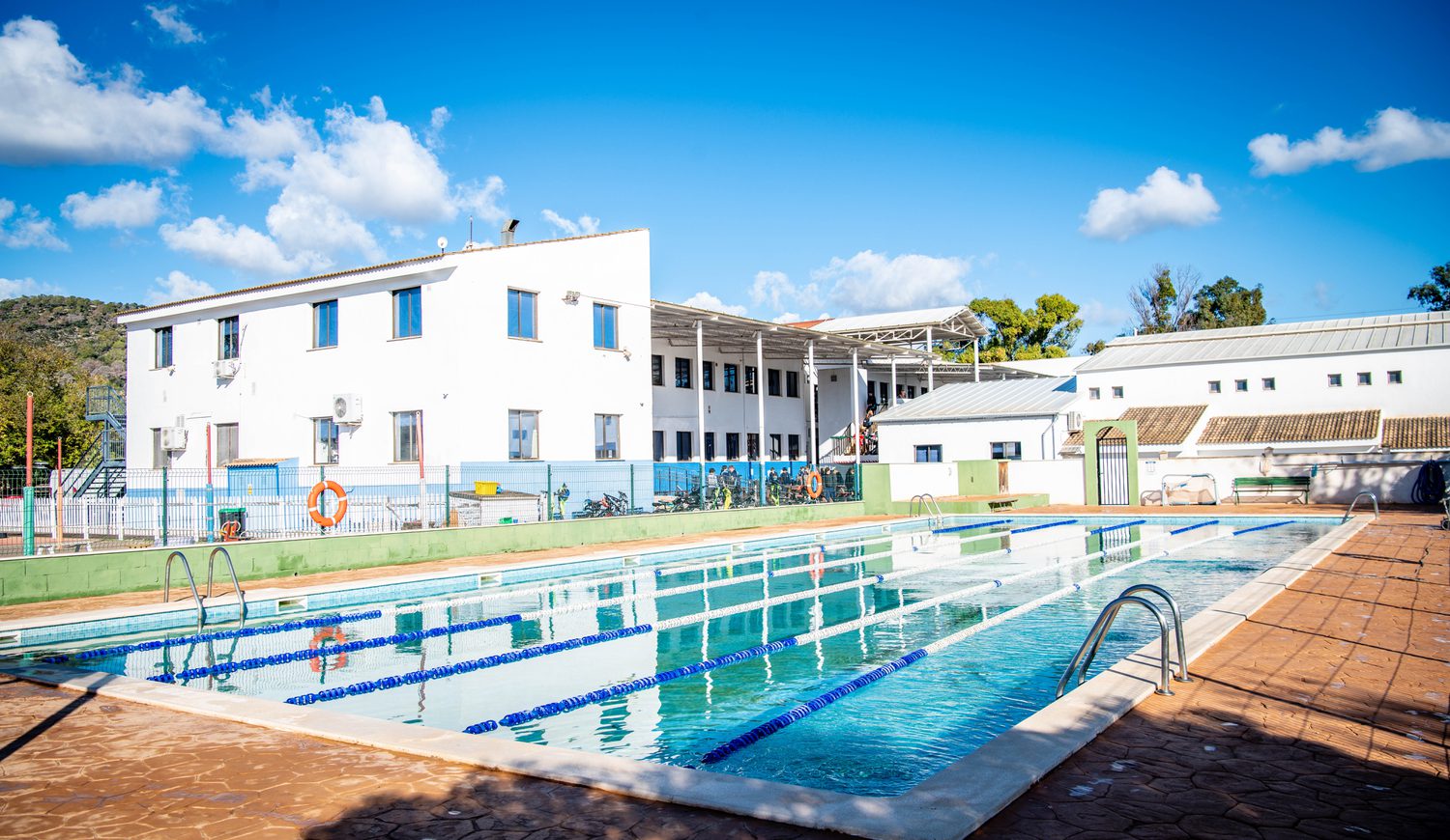 Swimming pool with school building in background