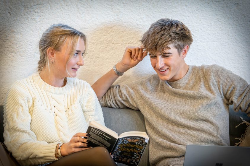 Two Sixth Formers reading a book in the Sixth Form room